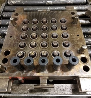 A custom rubber mold used to create rubber components.