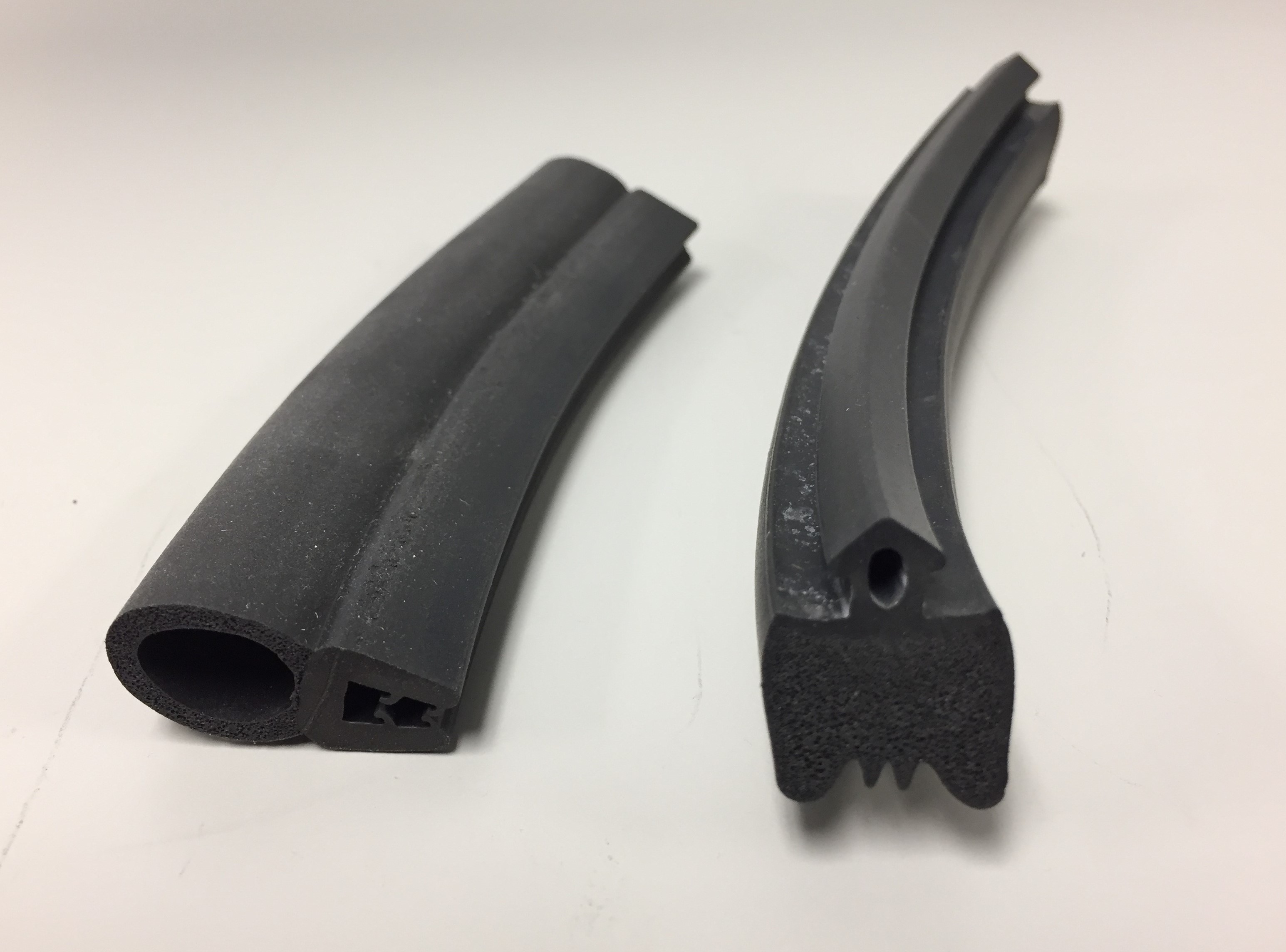 A pair of co-extruded rubber and sponge rubber components for sealing applications.